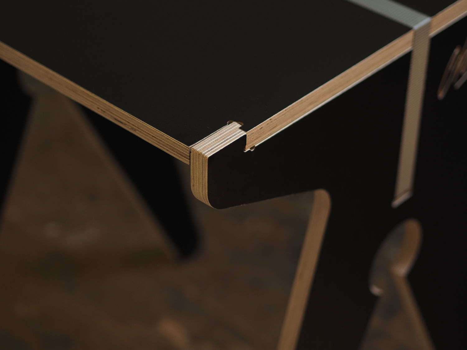 Close-up detail of a corher showing how the tabletop locks into the side panel, holding is firmly in place.