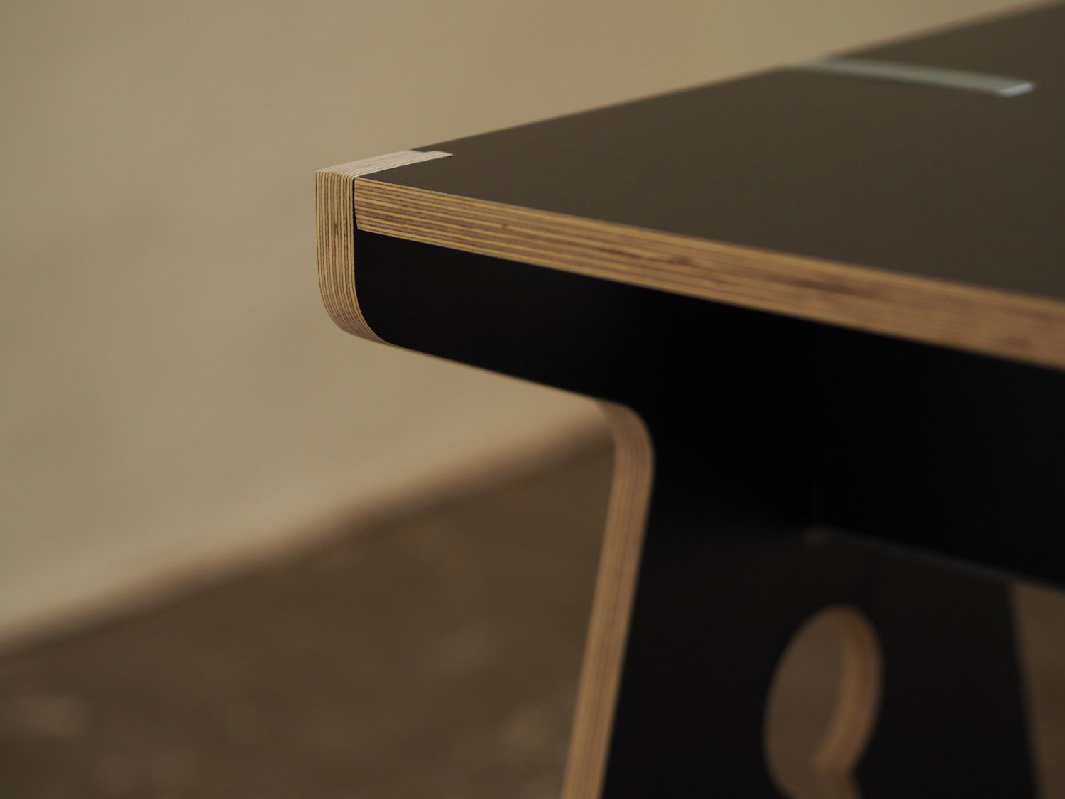 Detail of the corner of the table, clearly showing elegant shape of the clothing peg's shape.