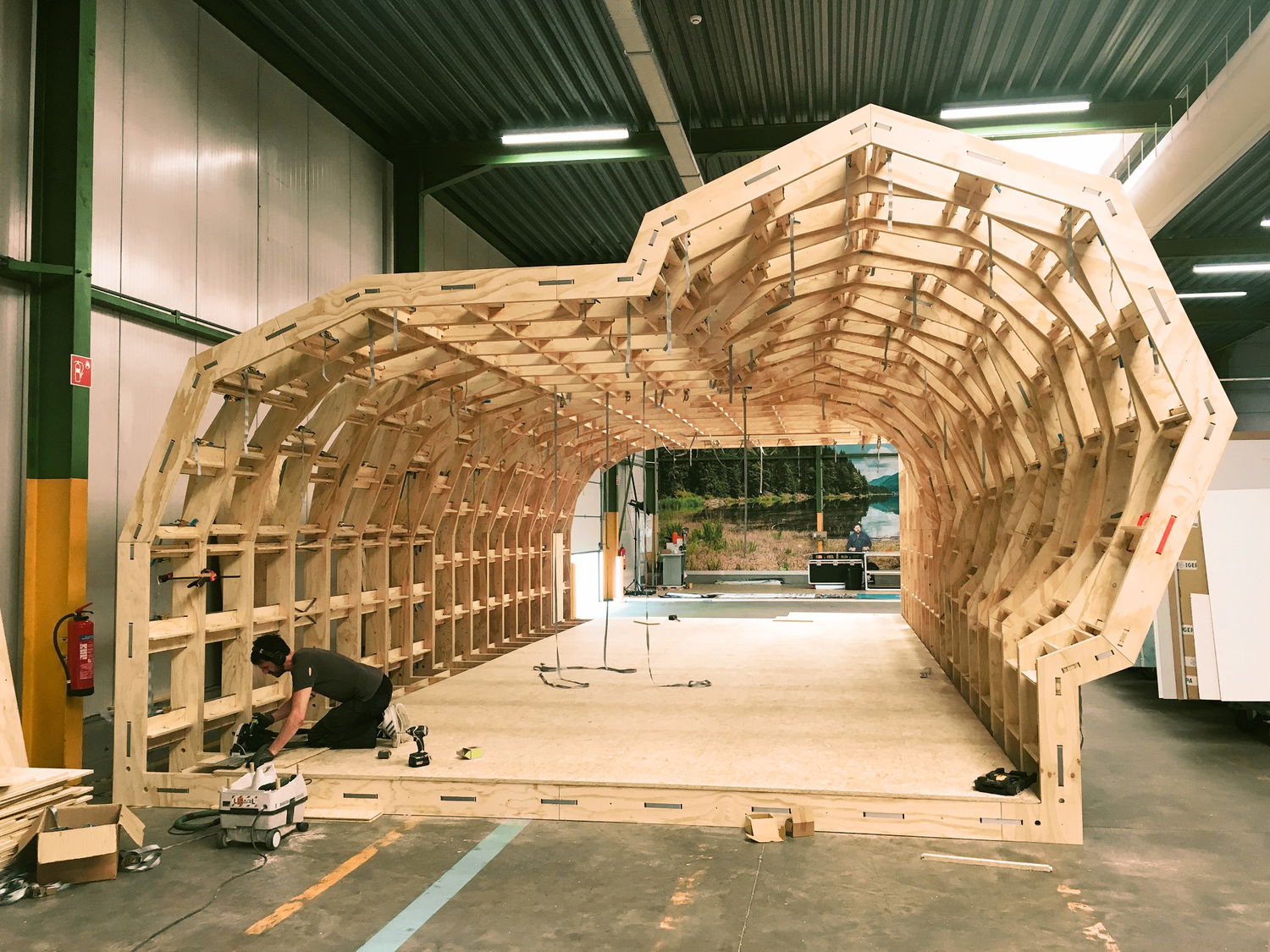 It's day nine and the last floor panel is being installed. Looking through the finished base structure from the left side where the profile is at its most expressive.